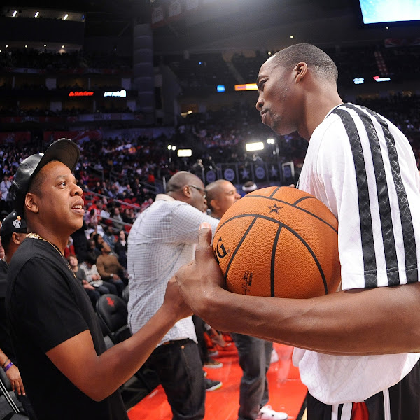 Dwight Howard #12 of the Western Conference All-Stars talks with recording artist Jay-Z during the 2013 NBA All-Star Game presented by Kia on February 17, 2013 at the Toyota Center in Houston, Texas.